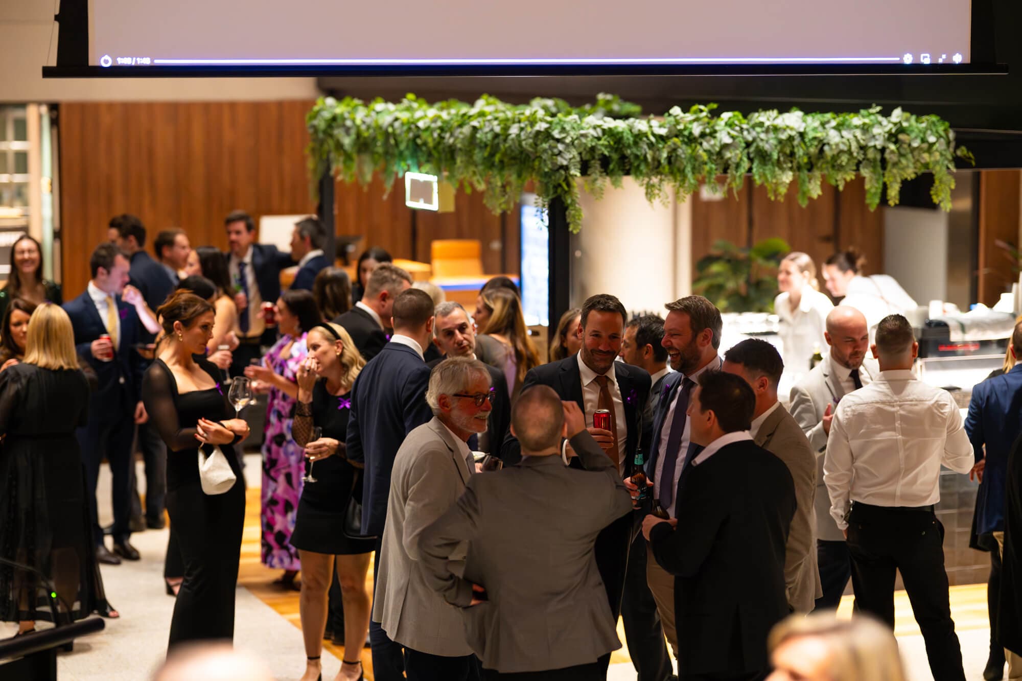 Guests on the dance floor under purple lights at the 2025 gala
