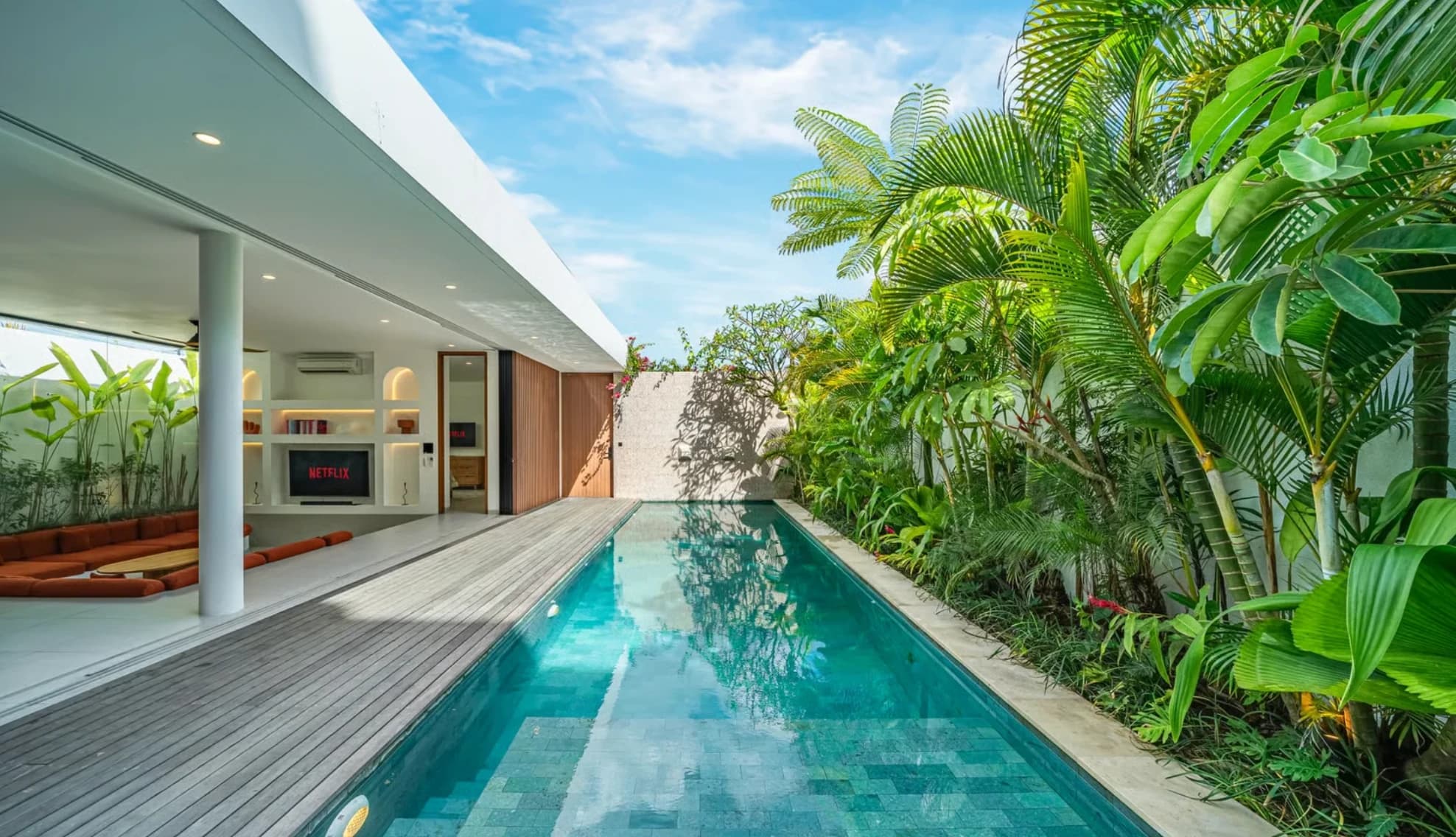 The pool, deck and tropical garden at a Palmstone Villa in Uluwatu, Bali